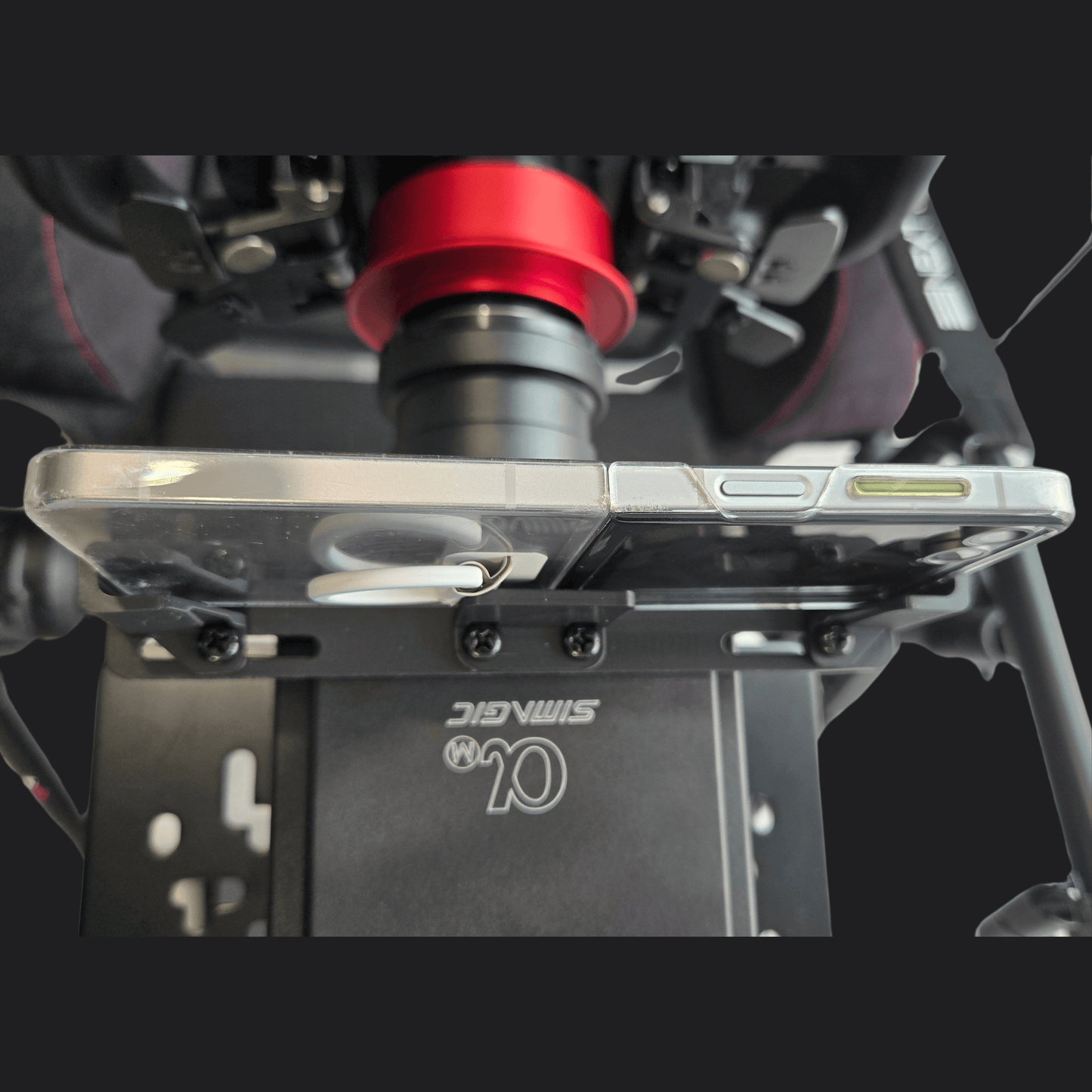 Simagic Phone Holder Dashboard securely mounted with smartphone for immersive racing experience.