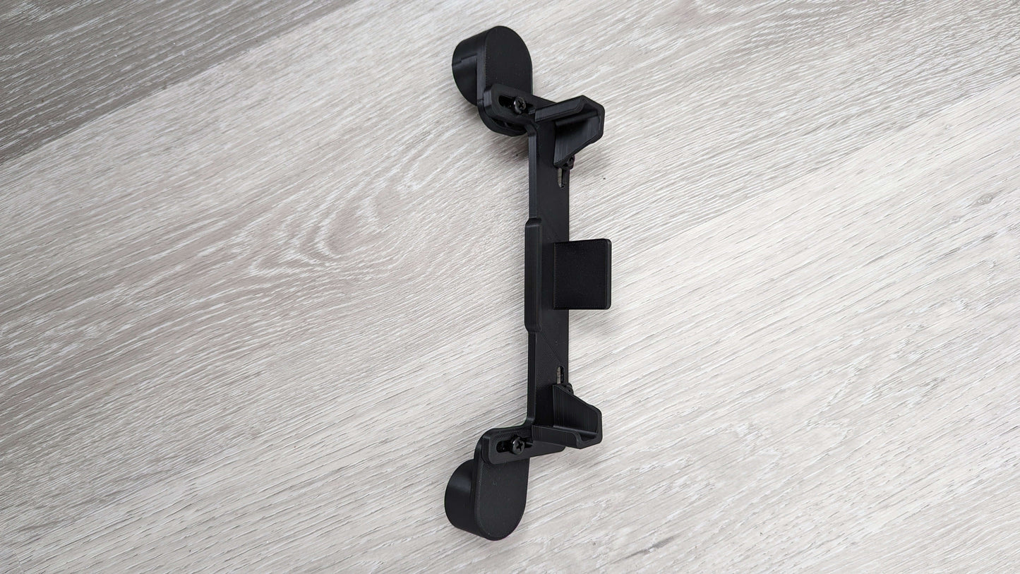 Dashboard Phone Holder Mod for Logitech G29, G923, G920, and G27 Racing Wheels in black color on a wood backdrop.