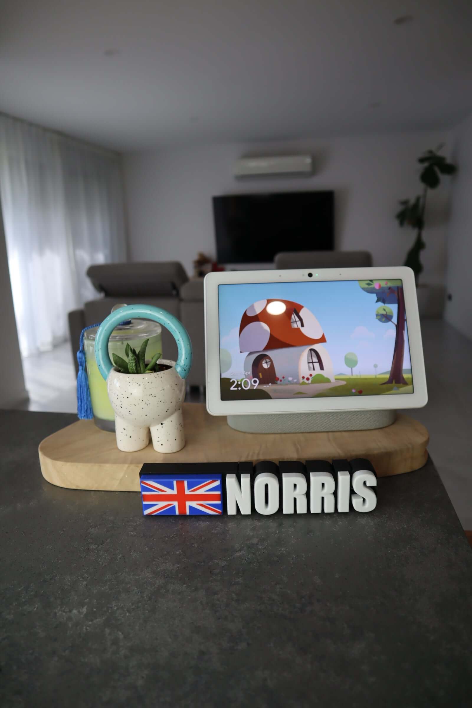 Custom Driver Name Plate for Norris with British flag displayed on a stylish tabletop setup.