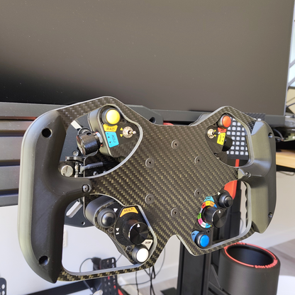 Formula Wheel Hub with advanced inputs and carbon fiber construction for professional sim racing.